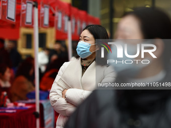 Job seekers are looking for suitable positions at a job fair for women in Fuyang, China, on March 6, 2024. (