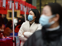 Job seekers are looking for suitable positions at a job fair for women in Fuyang, China, on March 6, 2024. (