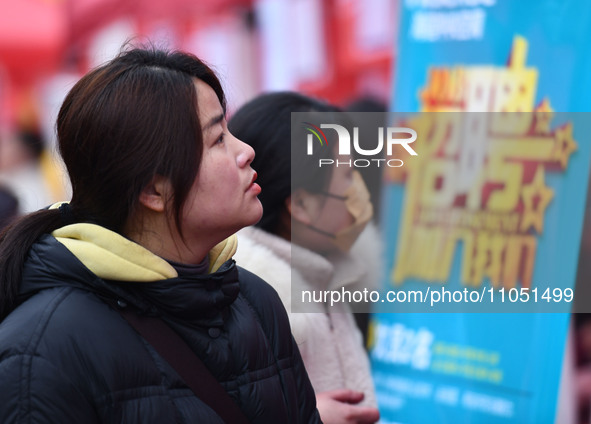 Job seekers are looking for suitable positions at a job fair for women in Fuyang, China, on March 6, 2024. 