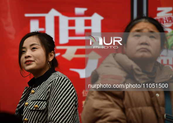 Job seekers are looking for suitable positions at a job fair for women in Fuyang, China, on March 6, 2024. 