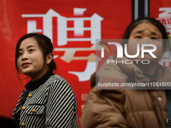 Job seekers are looking for suitable positions at a job fair for women in Fuyang, China, on March 6, 2024. (