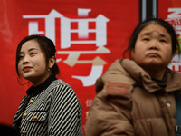 Job seekers are looking for suitable positions at a job fair for women in Fuyang, China, on March 6, 2024. (