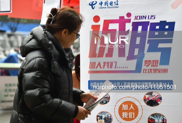 Job seekers are looking for suitable positions at a job fair for women in Fuyang, China, on March 6, 2024. 