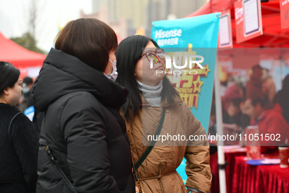 Job seekers are looking for suitable positions at a job fair for women in Fuyang, China, on March 6, 2024. 