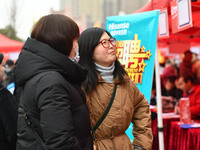 Job seekers are looking for suitable positions at a job fair for women in Fuyang, China, on March 6, 2024. (