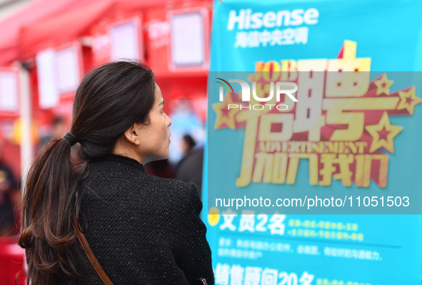 Job seekers are looking for suitable positions at a job fair for women in Fuyang, China, on March 6, 2024. 