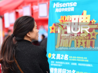 Job seekers are looking for suitable positions at a job fair for women in Fuyang, China, on March 6, 2024. (