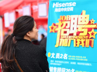 Job seekers are looking for suitable positions at a job fair for women in Fuyang, China, on March 6, 2024. (