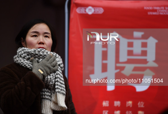 Job seekers are looking for suitable positions at a job fair for women in Fuyang, China, on March 6, 2024. 