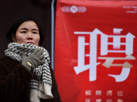 Job seekers are looking for suitable positions at a job fair for women in Fuyang, China, on March 6, 2024. (