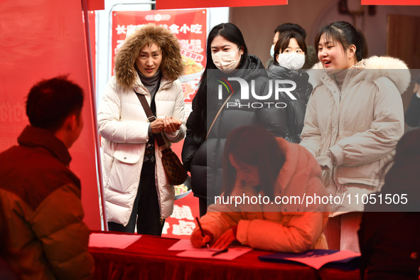 Job seekers are looking for suitable positions at a job fair for women in Fuyang, China, on March 6, 2024. 