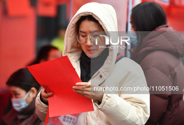 Job seekers are looking for suitable positions at a job fair for women in Fuyang, China, on March 6, 2024. 