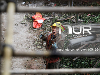 Construction workers are working at the renovation site of an old residential area in Wenhua Yi Village, Jiulongpo district, in Chongqing, C...