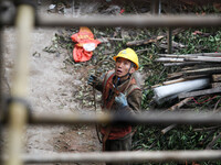 Construction workers are working at the renovation site of an old residential area in Wenhua Yi Village, Jiulongpo district, in Chongqing, C...