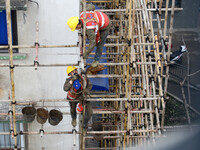 Construction workers are working at the renovation site of an old residential area in Wenhua Yi Village, Jiulongpo district, in Chongqing, C...