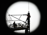 An overhead contact line worker from the Nanchang power supply section of Southern Railway is overhauling overhead contact line equipment in...