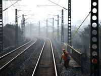 An overhead contact line worker at the Nanchang power supply section of China Southern Railway is hanging the ground wire at the Ruichang se...