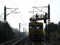 An overhead contact line worker from the Nanchang power supply section of Southern Railway is overhauling overhead contact line equipment in...