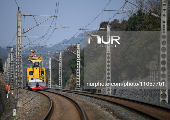 An overhead contact line worker from the Nanchang power supply section of Southern Railway is overhauling overhead contact line equipment in...