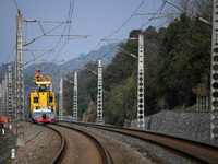 An overhead contact line worker from the Nanchang power supply section of Southern Railway is overhauling overhead contact line equipment in...