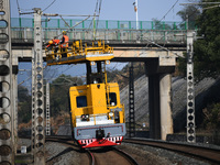 An overhead contact line worker from the Nanchang power supply section of Southern Railway is overhauling overhead contact line equipment in...