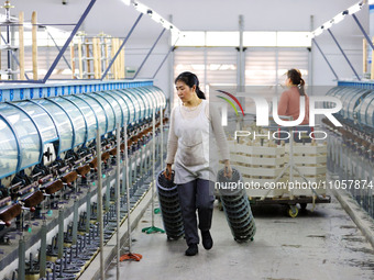 A female worker is working at a production workshop of a silk company in Chongqing, China, on March 8, 2024. (