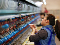 A female worker is working at a production workshop of a silk company in Chongqing, China, on March 8, 2024. (