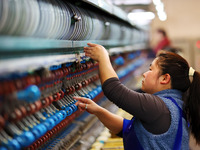 A female worker is working at a production workshop of a silk company in Chongqing, China, on March 8, 2024. (