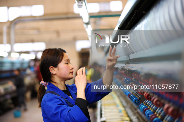 A female worker is working at a production workshop of a silk company in Chongqing, China, on March 8, 2024. 