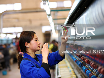 A female worker is working at a production workshop of a silk company in Chongqing, China, on March 8, 2024. (