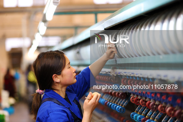 A female worker is working at a production workshop of a silk company in Chongqing, China, on March 8, 2024. 