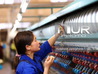 A female worker is working at a production workshop of a silk company in Chongqing, China, on March 8, 2024. (