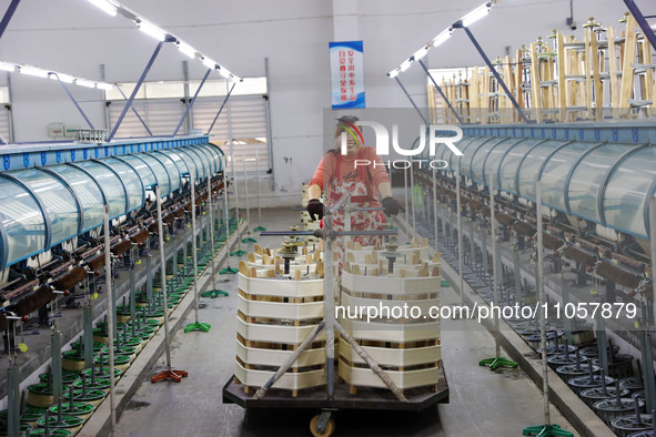 A female worker is working at a production workshop of a silk company in Chongqing, China, on March 8, 2024. 