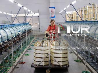 A female worker is working at a production workshop of a silk company in Chongqing, China, on March 8, 2024. (