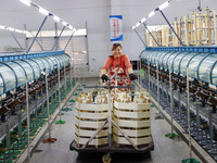 A female worker is working at a production workshop of a silk company in Chongqing, China, on March 8, 2024. (