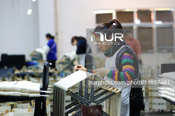 A female worker is working at a production workshop of a silk company in Chongqing, China, on March 8, 2024. 