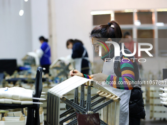 A female worker is working at a production workshop of a silk company in Chongqing, China, on March 8, 2024. (