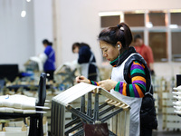 A female worker is working at a production workshop of a silk company in Chongqing, China, on March 8, 2024. (