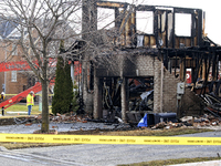 Demolition crews are waiting on the street in front of a home that was destroyed by a reported explosion and fire in Brampton, Ontario, Cana...