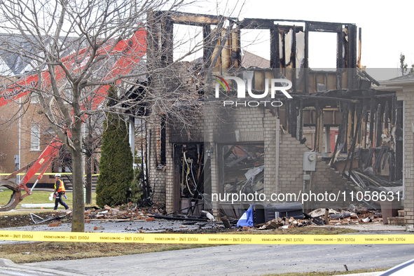 Demolition crews are walking in front of a home that is being torn down after it was destroyed by a reported explosion and fire in Brampton,...