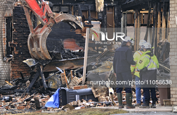 Demolition crews and fire officials are watching as a home is being torn down after it was destroyed by a reported explosion and fire in Bra...