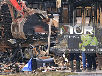 Demolition crews and fire officials are watching as a home is being torn down after it was destroyed by a reported explosion and fire in Bra...