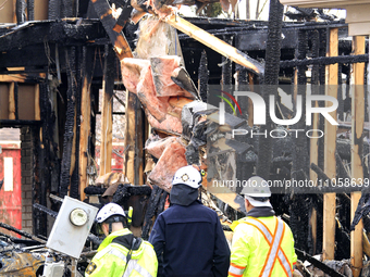 Demolition crews and fire officials are watching as a home is being torn down after it was destroyed by a reported explosion and fire in Bra...