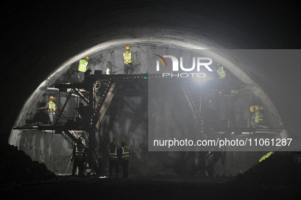 Workers are preparing for blasting at the exit of the Tiemengguan tunnel in Bazhou, Xinjiang province, China, on March 9, 2024. 