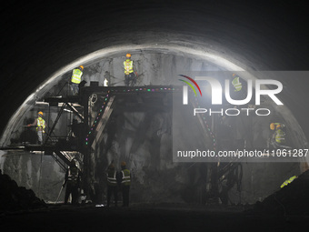 Workers are preparing for blasting at the exit of the Tiemengguan tunnel in Bazhou, Xinjiang province, China, on March 9, 2024. (