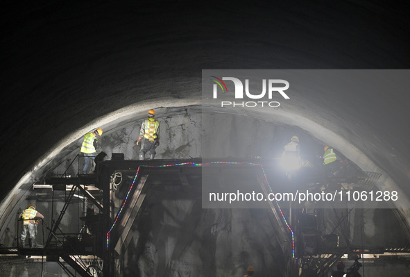 Workers are preparing for blasting at the exit of the Tiemengguan tunnel in Bazhou, Xinjiang province, China, on March 9, 2024. 