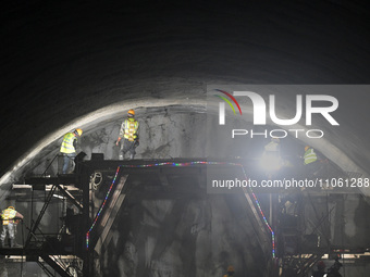 Workers are preparing for blasting at the exit of the Tiemengguan tunnel in Bazhou, Xinjiang province, China, on March 9, 2024. (