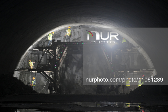 Workers are preparing for blasting at the exit of the Tiemengguan tunnel in Bazhou, Xinjiang province, China, on March 9, 2024. 