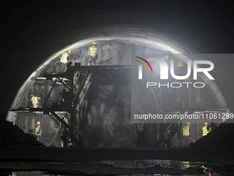 Workers are preparing for blasting at the exit of the Tiemengguan tunnel in Bazhou, Xinjiang province, China, on March 9, 2024. (