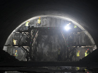 Workers are preparing for blasting at the exit of the Tiemengguan tunnel in Bazhou, Xinjiang province, China, on March 9, 2024. (